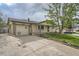 Charming single-story home with a brick facade, well-manicured lawn, and an attached garage at 755 Braun St, Lakewood, CO 80401