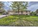 Lovely front yard featuring lush green grass and a well-maintained brick home exterior with a car in the driveway at 755 Braun St, Lakewood, CO 80401