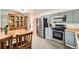 Functional kitchen with stainless steel appliances, light blue cabinets, and a dining area adjacent at 755 Braun St, Lakewood, CO 80401