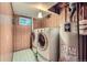 Convenient laundry room featuring a washer, dryer, and modern water heater at 755 Braun St, Lakewood, CO 80401