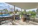 Covered patio featuring a Blackstone grill, hot tub, and outdoor dining set at 755 Braun St, Lakewood, CO 80401