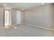 Light-filled bedroom with neutral walls, plush carpeting, and door at 1525 E 3Rd Ave, Longmont, CO 80501