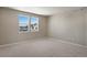 Bright bedroom featuring two windows, neutral walls, and plush carpeting at 1525 E 3Rd Ave, Longmont, CO 80501