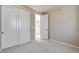 Bedroom with large closet, neutral walls, plush carpeting, and door to hall at 1525 E 3Rd Ave, Longmont, CO 80501