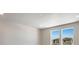 Bedroom with large windows offering bright natural light and neutral-colored walls and carpet at 1525 E 3Rd Ave, Longmont, CO 80501