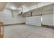 Spacious garage with concrete flooring, overhead lighting, and garage door at 1525 E 3Rd Ave, Longmont, CO 80501