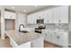 Stylish kitchen featuring white cabinets, granite counters, a gray backsplash, and stainless steel appliances at 1525 E 3Rd Ave, Longmont, CO 80501
