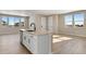 Bright and airy kitchen island with granite counters, stainless dishwasher, and hardwood floors in an open floor plan at 1525 E 3Rd Ave, Longmont, CO 80501