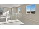 Upper landing with white railings, neutral carpeting, and natural light from multiple windows at 1525 E 3Rd Ave, Longmont, CO 80501