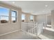 Upstairs landing with white banisters, multiple windows with bright views and recessed lighting at 1525 E 3Rd Ave, Longmont, CO 80501