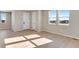 Bright living room with hardwood floors, neutral walls, and sunny windows offering a view at 1525 E 3Rd Ave, Longmont, CO 80501