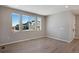 Open living space featuring wood floors, neutral paint, and large windows with neighborhood views at 1525 E 3Rd Ave, Longmont, CO 80501