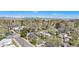 Expansive aerial view of a quiet residential neighborhood, showcasing mature trees and distant mountain views against a blue sky at 4196 S Pennsylvania St, Englewood, CO 80113