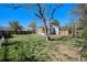Spacious backyard with mature trees, green grass, and a wooden fence around the property at 4196 S Pennsylvania St, Englewood, CO 80113