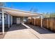 Covered carport offering ample parking space and side door to the main house, fenced for privacy at 4196 S Pennsylvania St, Englewood, CO 80113