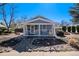 Cozy house with a front porch, complemented by a stone walkway and rock garden at 4196 S Pennsylvania St, Englewood, CO 80113