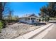 Charming home with a welcoming front porch, rock garden, and blue skies at 4196 S Pennsylvania St, Englewood, CO 80113