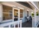 Inviting covered front porch with seating and decorative details, showcasing the home's entrance at 4196 S Pennsylvania St, Englewood, CO 80113