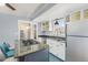 Stylish kitchen with gas range, granite countertops, and a stainless steel refrigerator and other modern appliances at 4196 S Pennsylvania St, Englewood, CO 80113