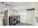 Well-organized laundry room featuring front loading washer and dryer, utility sink, and closet for storage at 4196 S Pennsylvania St, Englewood, CO 80113
