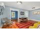 Sunny living room featuring hardwood floors, dining area, and connection to the adjacent room at 4196 S Pennsylvania St, Englewood, CO 80113