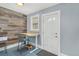 Bright home office featuring modern adjustable desk, accent wall, and natural light at 4196 S Pennsylvania St, Englewood, CO 80113