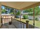 View from a covered back porch overlooking a grassy backyard with mature trees and a shed at 1049 Galena St, Aurora, CO 80010