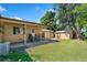 Backyard featuring the porch, storage shed, grass lawn, and mature trees at 1049 Galena St, Aurora, CO 80010