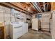 Unfinished basement features laundry and extra storage at 1049 Galena St, Aurora, CO 80010