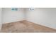 Unfinished basement area with two small windows and carpeted floors at 1049 Galena St, Aurora, CO 80010
