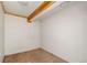 Unfinished basement featuring carpeted floors and overhead lighting with exposed wooden beams at 1049 Galena St, Aurora, CO 80010