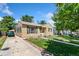 Single story home featuring green shutters, a manicured lawn, and a long driveway at 1049 Galena St, Aurora, CO 80010
