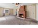 Cozy living room with a large brick fireplace, ceiling fan, and neutral-toned walls at 1049 Galena St, Aurora, CO 80010
