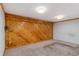 Spacious room features wood walls and carpeted flooring at 1049 Galena St, Aurora, CO 80010