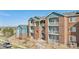Charming condo building featuring brick facade, balconies, and well-maintained landscaping at 2705 S Danube Way # 101, Aurora, CO 80013