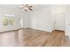 Spacious living room with a glass patio door and beautiful wood-look flooring at 2705 S Danube Way # 101, Aurora, CO 80013