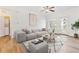 Cozy living room with plenty of natural light, a comfortable sofa, and in-unit laundry at 2705 S Danube Way # 101, Aurora, CO 80013