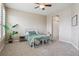 Comfortable carpeted bedroom with neutral walls, ceiling fan and a full-size bed with windows providing natural light at 10184 Park Meadows Dr # 1303, Lone Tree, CO 80124