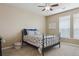 Cozy bedroom featuring neutral walls, plush carpet, and a large window letting in natural light at 10184 Park Meadows Dr # 1303, Lone Tree, CO 80124