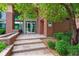 Building entrance features brick facade and stone steps, creating a welcoming approach at 10184 Park Meadows Dr # 1303, Lone Tree, CO 80124