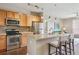 Modern kitchen featuring stainless steel appliances, granite counters, and bar seating at 10184 Park Meadows Dr # 1303, Lone Tree, CO 80124