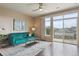Bright living room with a plush blue sofa, modern décor, and sliding glass doors to a patio at 10184 Park Meadows Dr # 1303, Lone Tree, CO 80124