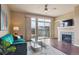 Cozy living room with fireplace, hardwood floors, and balcony access at 10184 Park Meadows Dr # 1303, Lone Tree, CO 80124