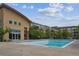 Outdoor community swimming pool with a well-kept pool deck and adjacent buildings with tree landscaping around at 10184 Park Meadows Dr # 1303, Lone Tree, CO 80124