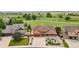 Expansive aerial view of a well-maintained home with a three-car garage, landscaped yard, and open green space behind the home at 1100 Columbine Way, Erie, CO 80516
