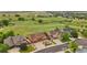 Aerial view of homes nestled in a vibrant neighborhood surrounded by lush greenery and scenic landscapes at 1100 Columbine Way, Erie, CO 80516