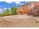 The backyard offers a cozy stone patio and stairs that lead to the deck, perfect for outdoor gatherings at 1100 Columbine Way, Erie, CO 80516