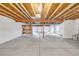 Unfinished basement with concrete floor, exposed wood ceiling, and visible utilities. A blank canvas awaiting your vision at 1100 Columbine Way, Erie, CO 80516