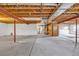 Unfinished basement with concrete floor, exposed wood ceiling, and visible utilities offering possibilities for renovation at 1100 Columbine Way, Erie, CO 80516