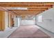 Unfinished basement with concrete floor, a bit of carpet and exposed wood ceiling offering possibilities for renovation at 1100 Columbine Way, Erie, CO 80516